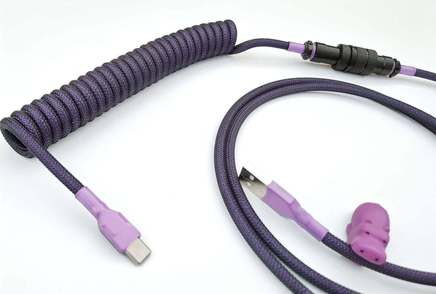 Dark purple coiled keyboard cable with black Aviator connector, light purple heat-shrink, USB C to A connection and purple cable bite protector