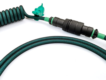 Fully customizeable coil cable for GMK Terror Below keycaps with black Gx16 Aviator connector and green heat-shrink.