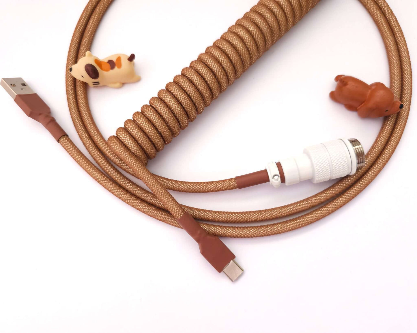 Brown coiled cable with Aviator connector in white and brown heat shrink, and cable bite protectors