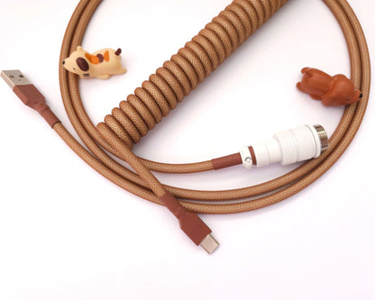 Brown coiled cable with Aviator connector in white and brown heat shrink, and cable bite protectors