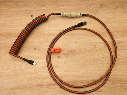 Coiled keyboard cable for Carbon keycaps  with orange coil, beige Gx16 and black heat shrink