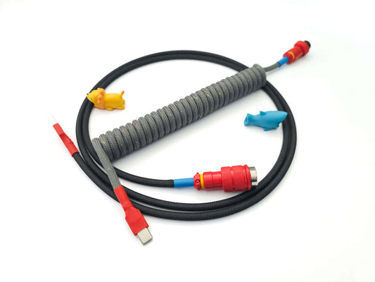 Coiled cable matching GMK Oblivion keycaps with red Gx16, red heat shrink and USB C to A connection.