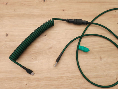 Dark green coiled keyboard cable for green Mechanical keyboards and keycaps.