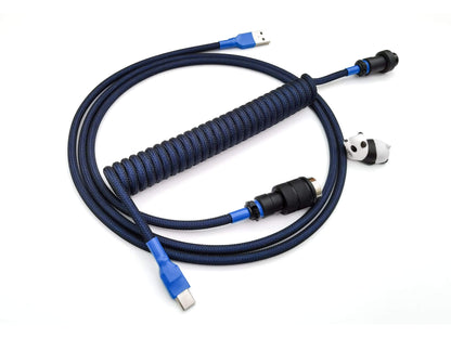 Coiled cable for GMK Blue samurai keycaps with black Gx16 connector, blue heat-shrink and USB C connection and panda cable bite