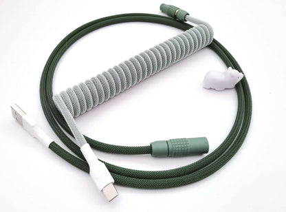 Coiled keyboard cable designed for GMK Botanical keycaps. With dark green Lemo, light green coil, and white heat-shrink.