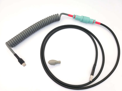 GMK Modern Dolch matching coiled USB cable with teal Gx16 and black and red heat shrink.