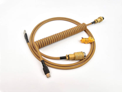 Coiled keyboard cable in gold colors with black heat shrink and Gx16 connector