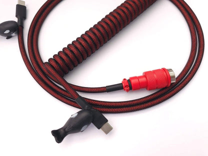 Coiled cable for red keycaps wIth red Aviator connector, USB C to C connection, and black heat-shrink and black cable bite orca