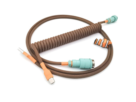 Coiled cable for 1976 keycaps with teal Gx16 connector, orange heat shrink, brown coil, and USB C connection
