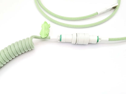 White Gx16 Aviator connector on pastel green coil cable with cable bite protector
