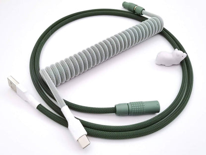 Dark and light green coiled keyboard cable with dark green Lemo connector, matching GMK Botanical keycaps.